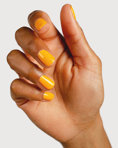 Sunflower yellow nail polish hand swatch on medium skin tone