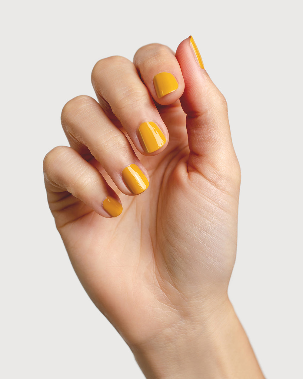 Tuscan sun yellow nail polish hand swatch on fair skin tone
