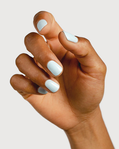 Pastel blue pastel nail polish hand swatch on medium skin tone
