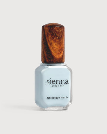 Pastel blue nail polish glass bottle with timber cap
