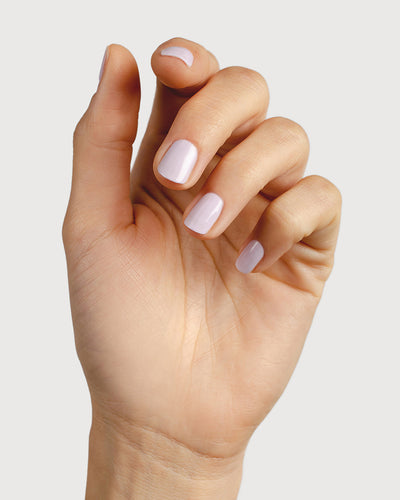 Light lilac pastel nail polish hand swatch on fair skin tone