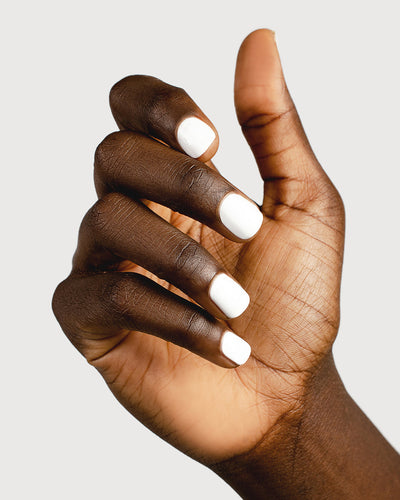 Crisp snow white nail polish hand swatch on dark skin tone